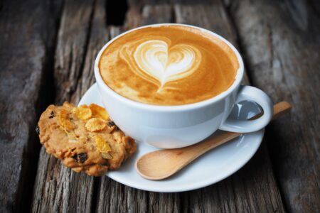 cup of coffee and cookie in coffee shop vintage color
